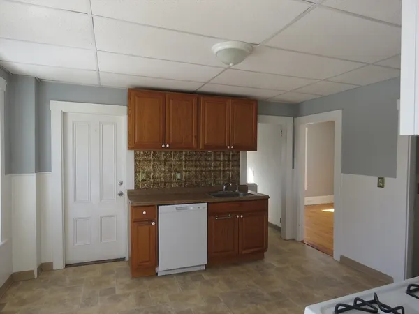 a kitchen with kitchen island a sink stainless steel appliances and cabinets