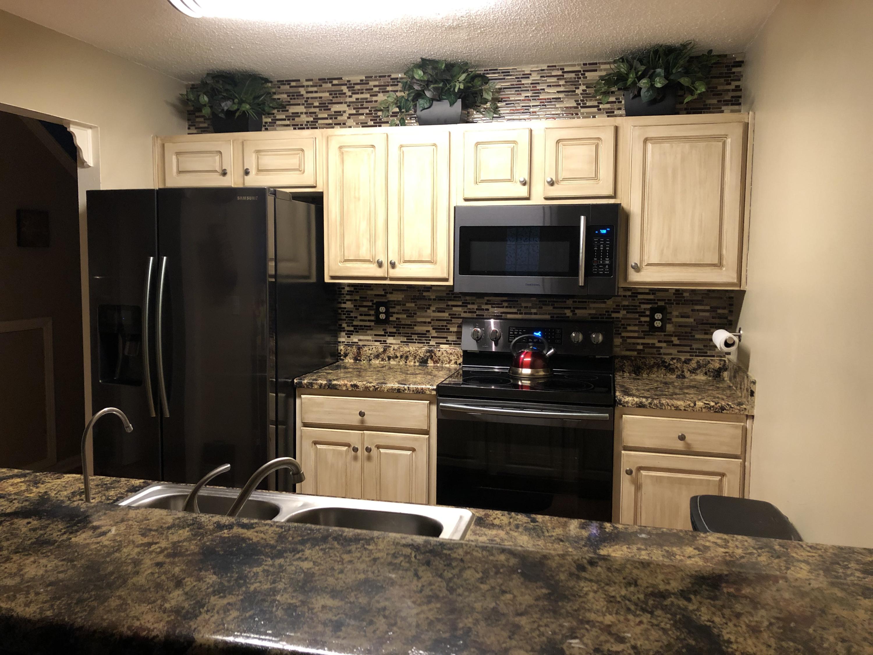 506 Keystone Road Mary Esther, FL 32569 - Photo 12 of 17 a kitchen with stainless steel appliances granite countertop a stove a refrigerator and a microwave