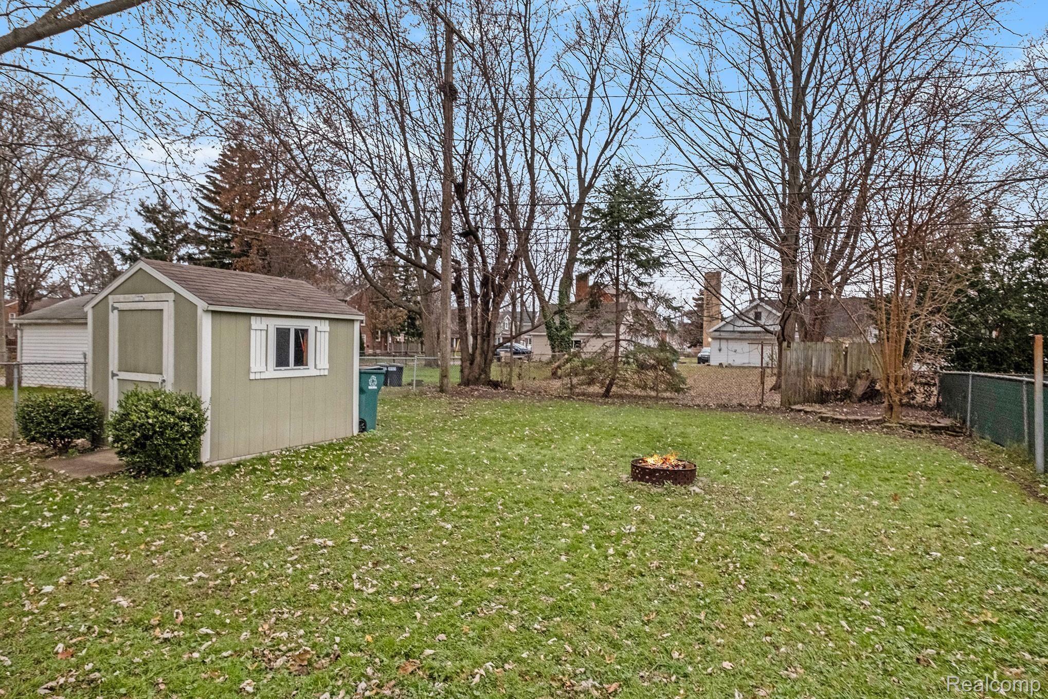2125 Dorothea Road Berkley, MI 48072 - Photo 22 of 24 Large shed, mature trees lining rear of yard, far away to impress and not be of any danger to home!
