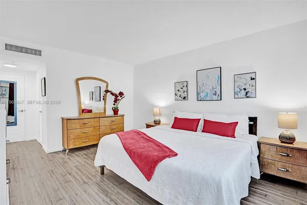 a bedroom with a bed and a dresser