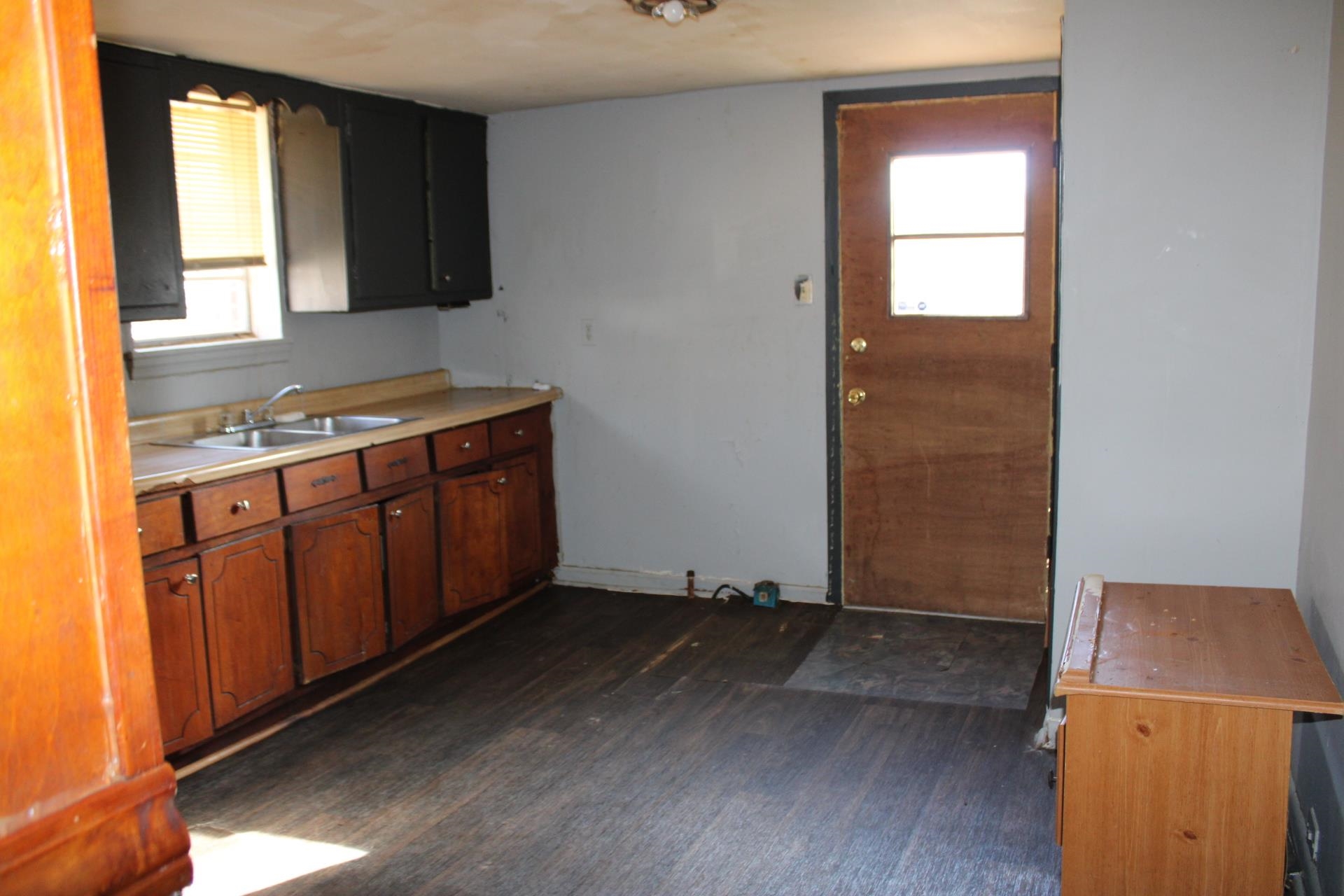 146 Center Street Ripley, TN 38063 - Photo 7 of 18 an empty room with windows and cabinet