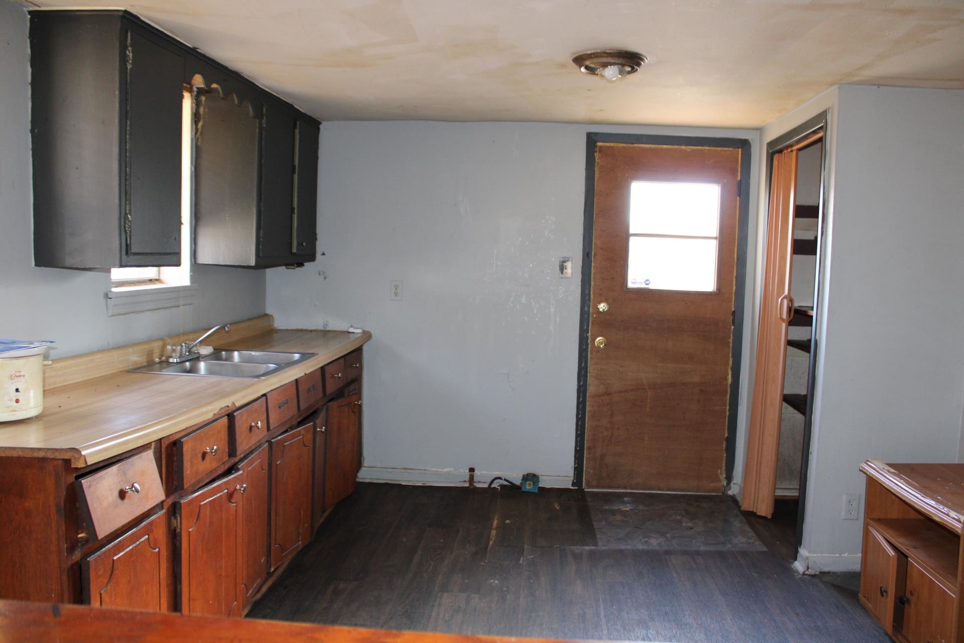 146 Center Street Ripley, TN 38063 - Photo 8 of 18 a kitchen with a sink stove and cabinets