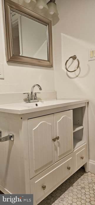 44693 White Oak Court, Unit 2B California, MD 20619 - Photo 13 of 14 a bathroom with a sink a vanity and a mirror