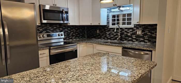 44693 White Oak Court, Unit 2B California, MD 20619 - Photo 2 of 14 a kitchen with a sink stove and refrigerator