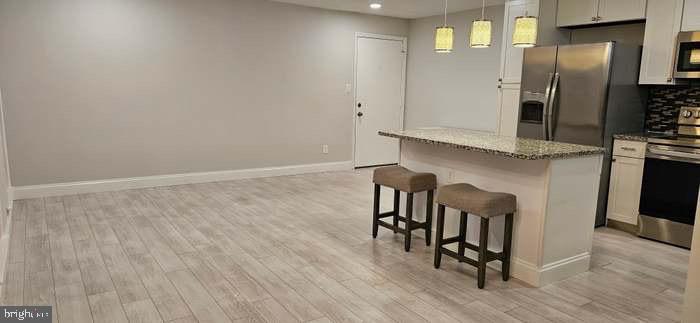 44693 White Oak Court, Unit 2B California, MD 20619 - Photo 8 of 14 an empty room with wooden floor and windows