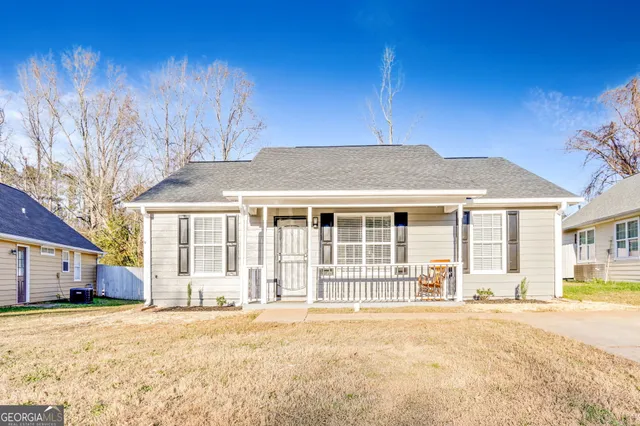 a bedroom with a bed and a lamp