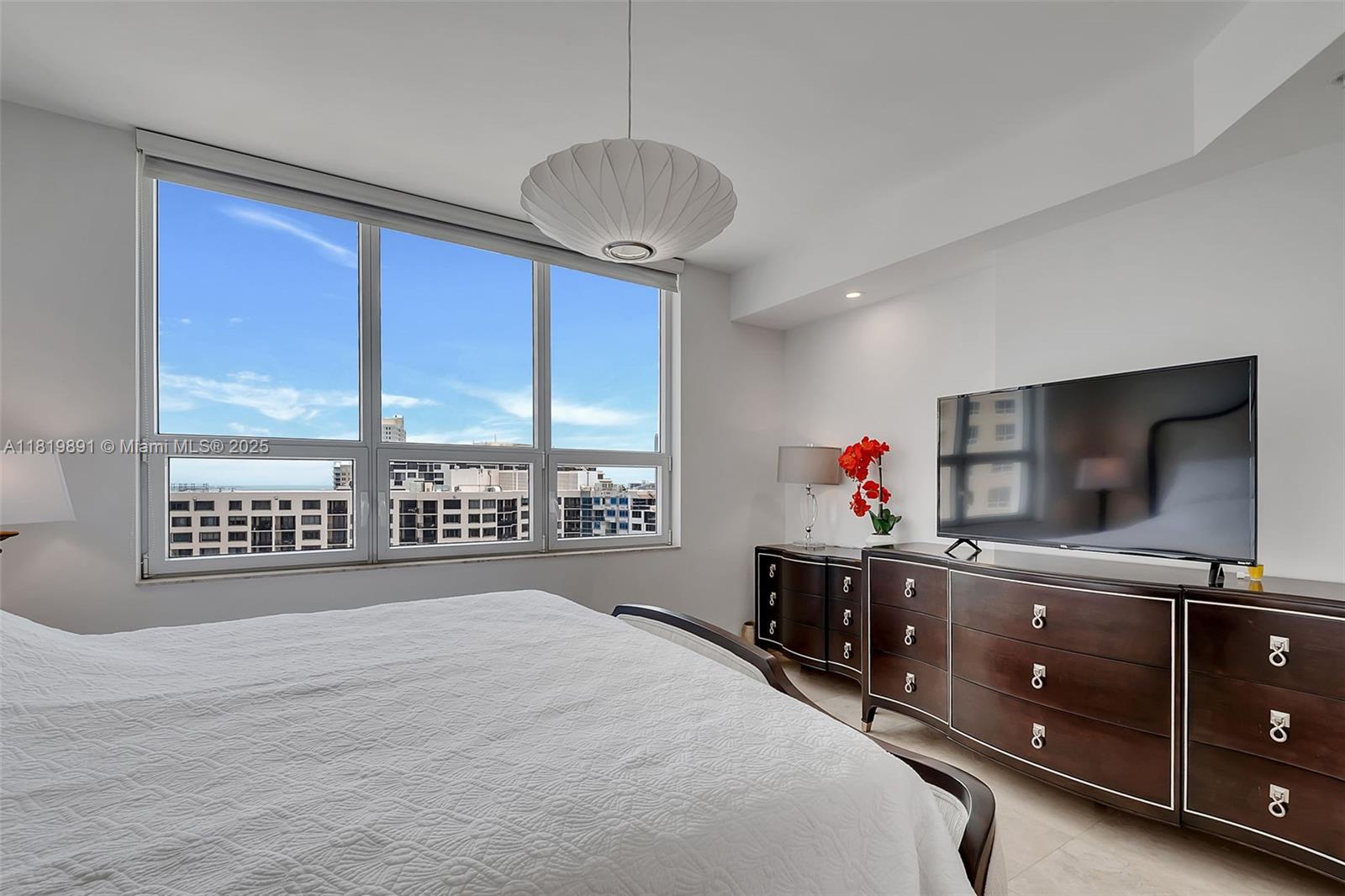 848 Brickell Key Drive, Unit 1803 Miami, FL 33131 - Photo 12 of 25 a room with furniture and a flat screen tv