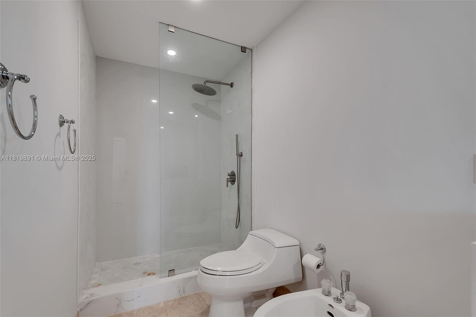 848 Brickell Key Drive, Unit 1803 Miami, FL 33131 - Photo 14 of 25 a bathroom with a toilet and a shower