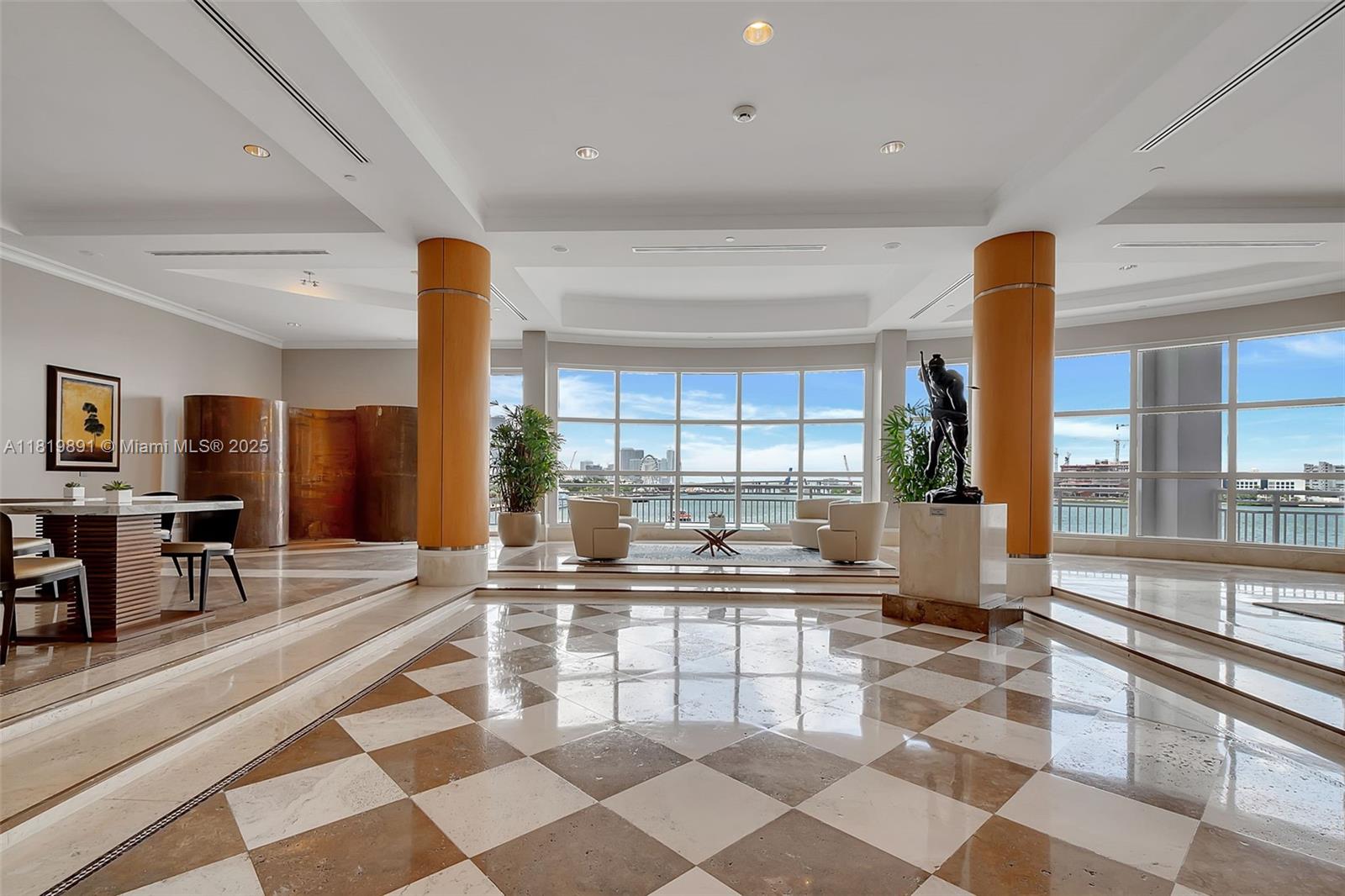 848 Brickell Key Drive, Unit 1803 Miami, FL 33131 - Photo 24 of 25 a kitchen with a large window cabinets and living room view