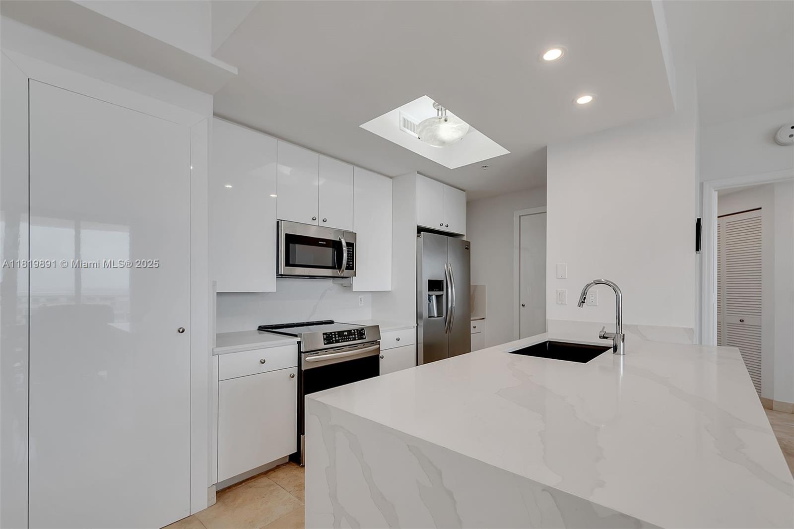 848 Brickell Key Drive, Unit 1803 Miami, FL 33131 - Photo 4 of 25 a bedroom with a bed and a television