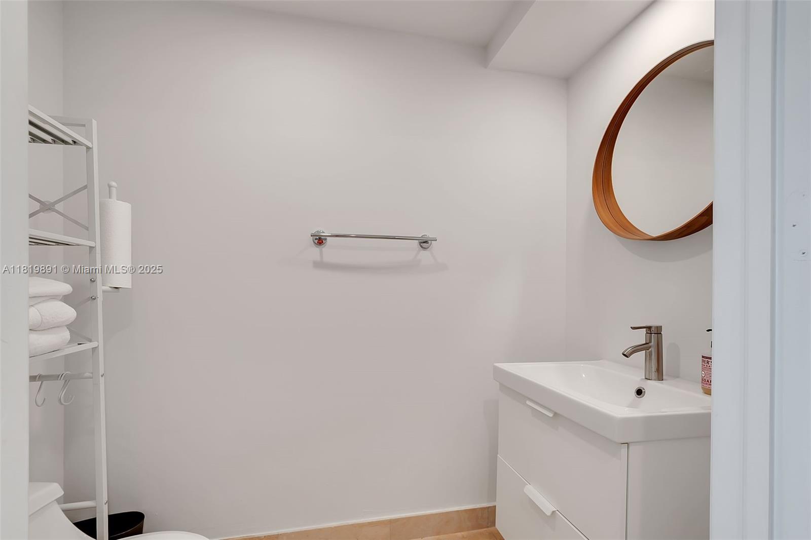 848 Brickell Key Drive, Unit 1803 Miami, FL 33131 - Photo 6 of 25 a bathroom with a sink and a mirror