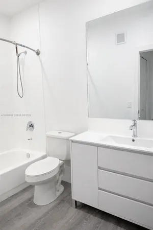 a bathroom with a sink a toilet and a bathtub