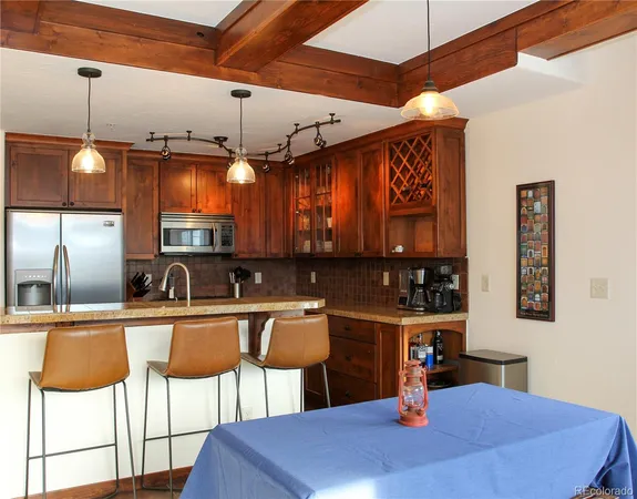 a kitchen with a sink a stove and chairs