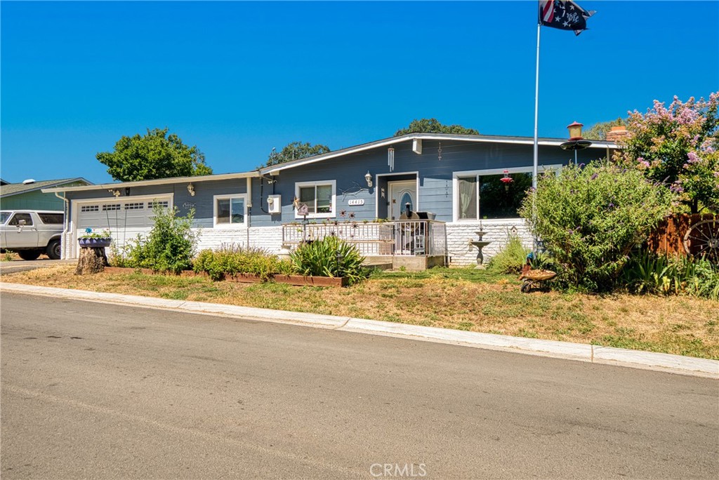 a front view of a house with a yard and potted plants