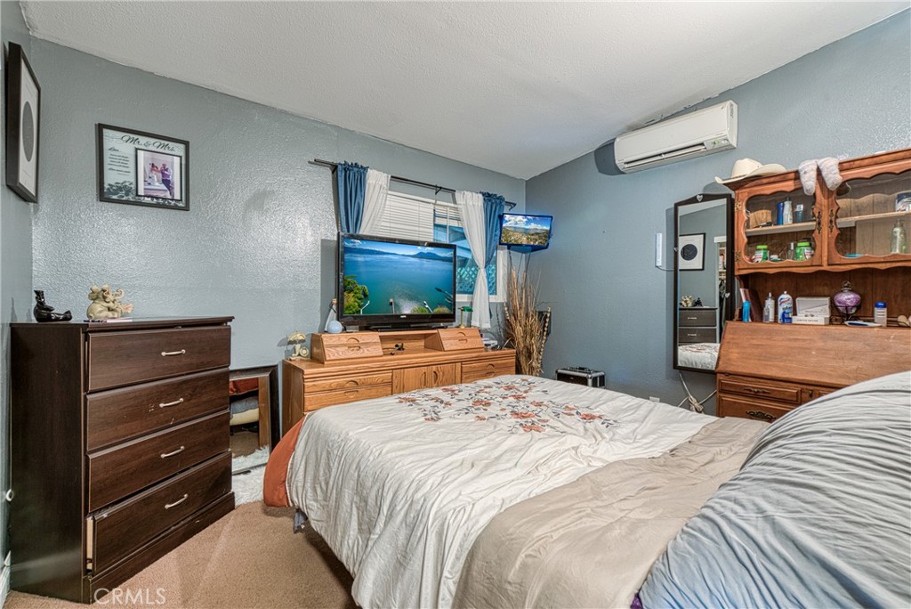 14415 Ridge Road Clearlake, CA 95422 - Photo 15 of 28 a bedroom with a bed and a flat screen tv