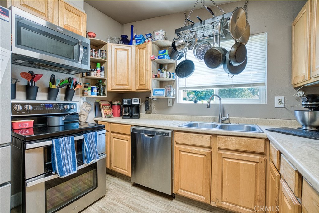 14415 Ridge Road Clearlake, CA 95422 - Photo 18 of 28 a kitchen with stainless steel appliances granite countertop a sink and cabinets