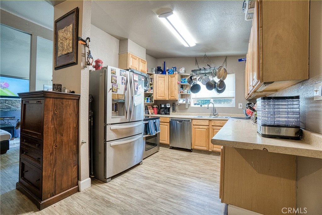 14415 Ridge Road Clearlake, CA 95422 - Photo 20 of 28 a kitchen with stainless steel appliances granite countertop a refrigerator and a sink