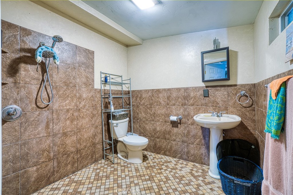 14415 Ridge Road Clearlake, CA 95422 - Photo 25 of 28 a bathroom with a sink toilet and a shower