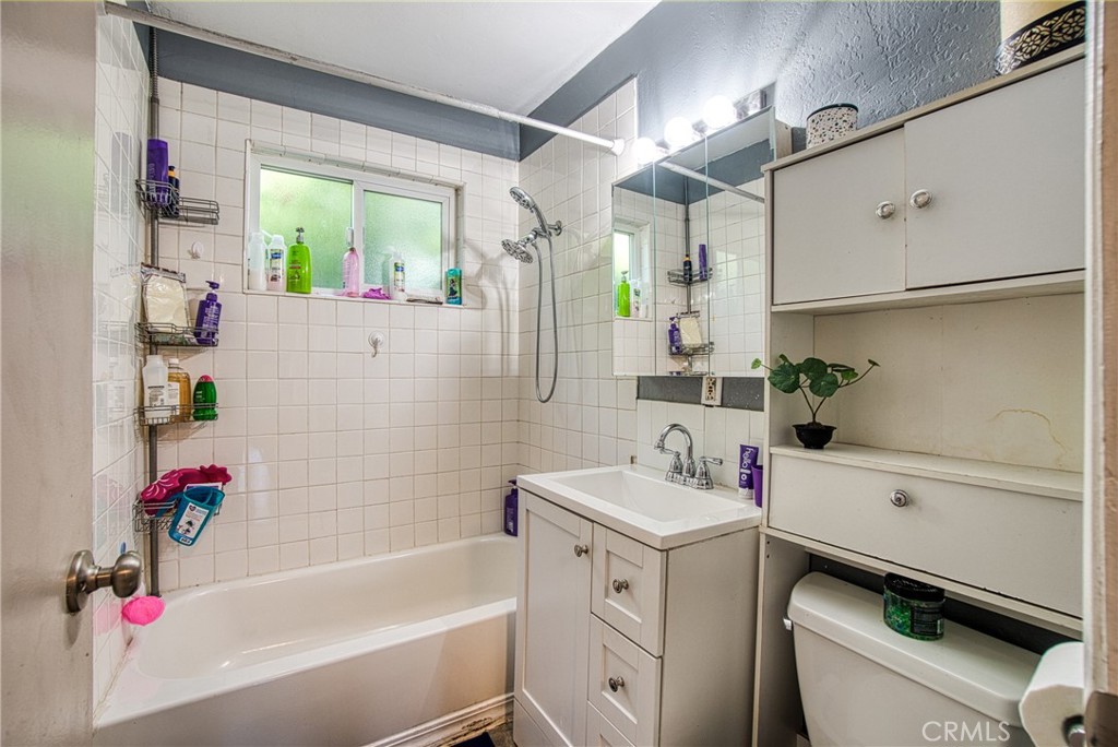 14415 Ridge Road Clearlake, CA 95422 - Photo 9 of 28 a bathroom with a sink vanity tub and toilet