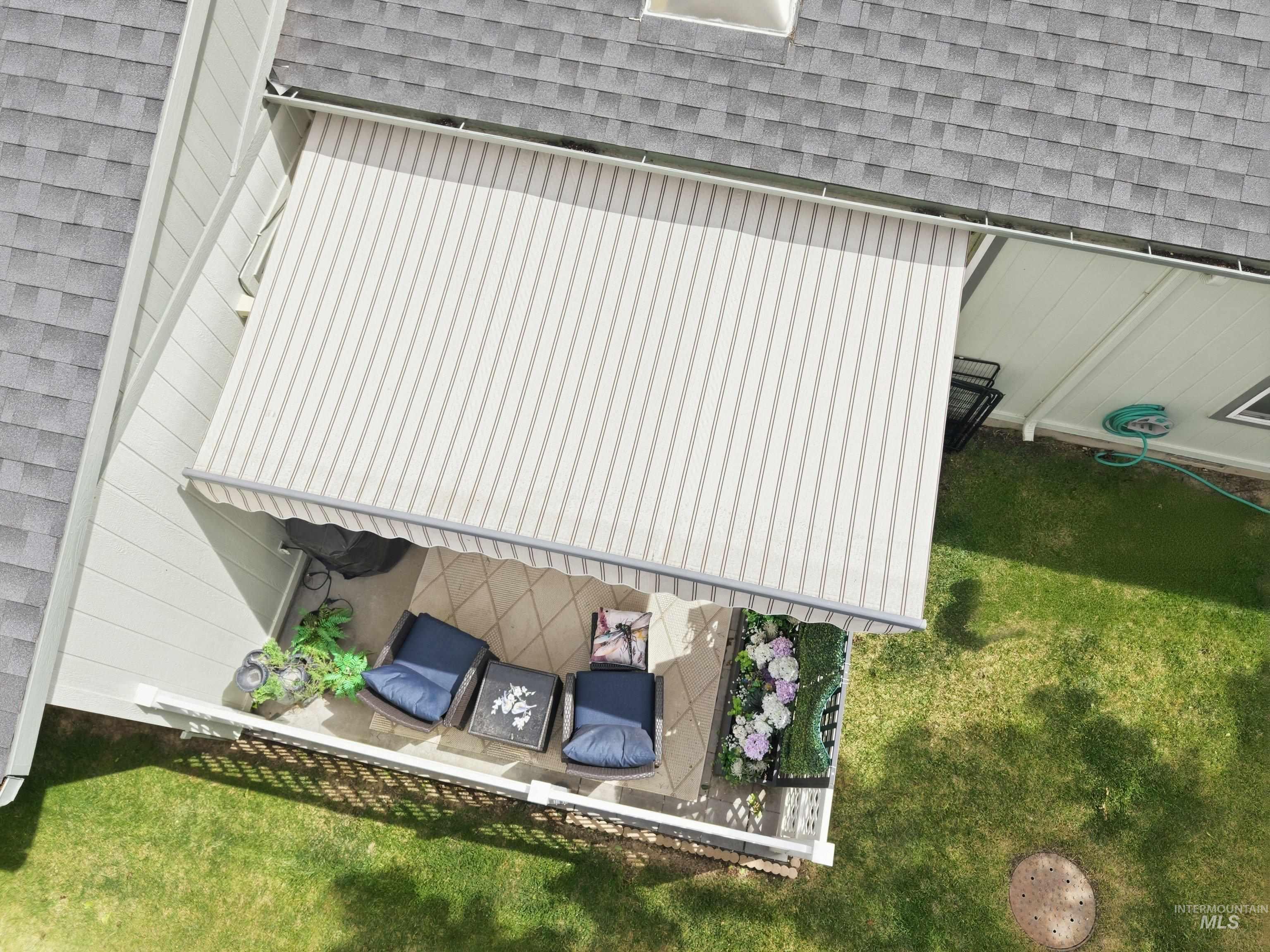 421 South Curtis Road, Unit 202 202 Boise, ID 83705 - Photo 39 of 41 Outdoor patio featuring a striped retractable awning, tiled flooring, and white railing