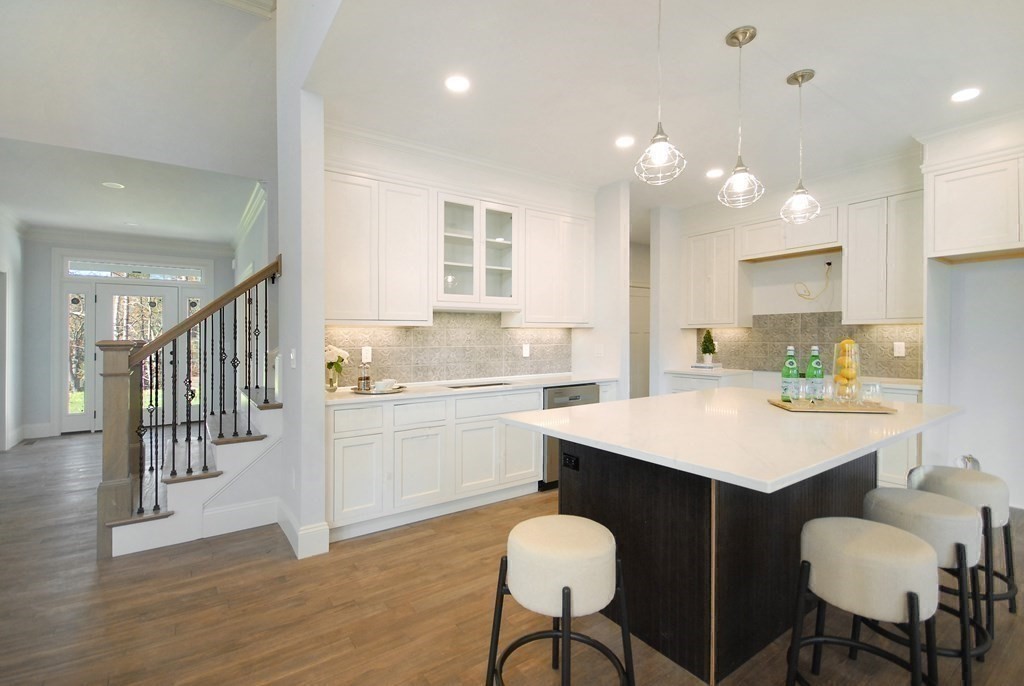 73 Seminole Road Acton, MA 01720 - Photo 13 of 33 a kitchen with a dining table chairs refrigerator and cabinets