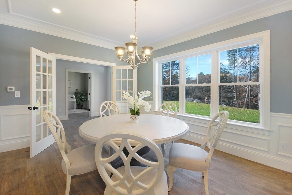 73 Seminole Road Acton, MA 01720 - Photo 20 of 33 a view of a dining room with furniture large windows and wooden floor