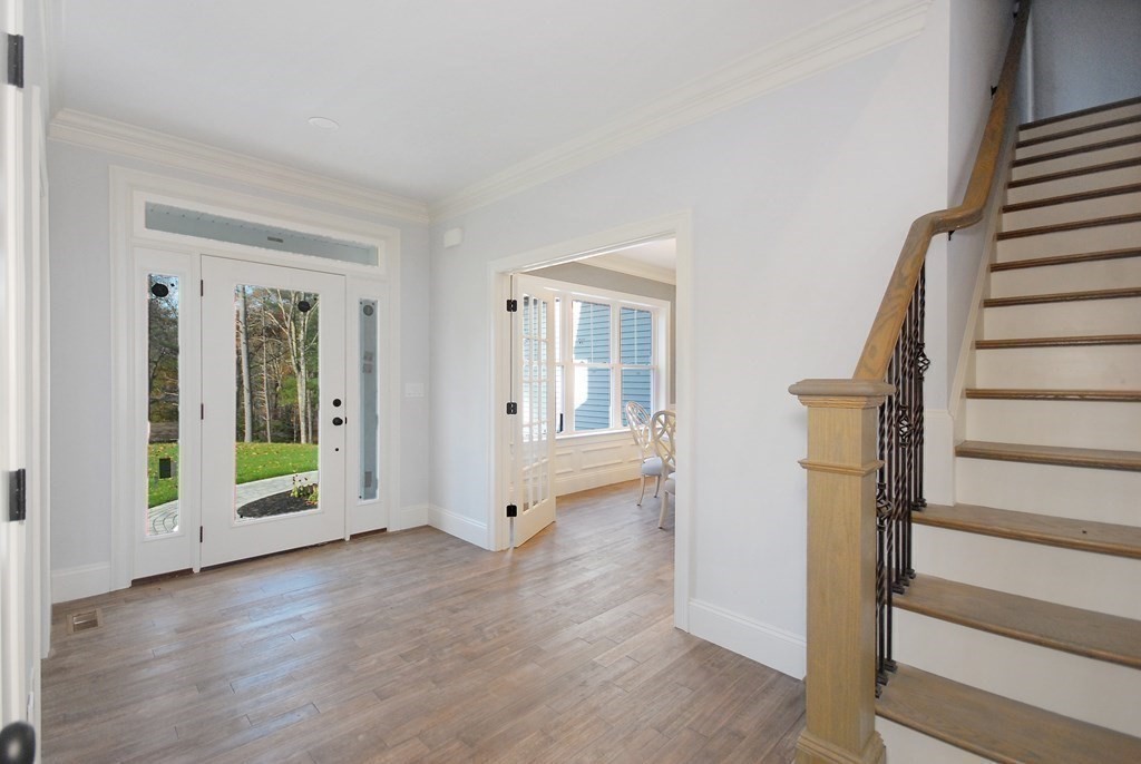 73 Seminole Road Acton, MA 01720 - Photo 7 of 33 a view of an empty room with wooden floor and stairs