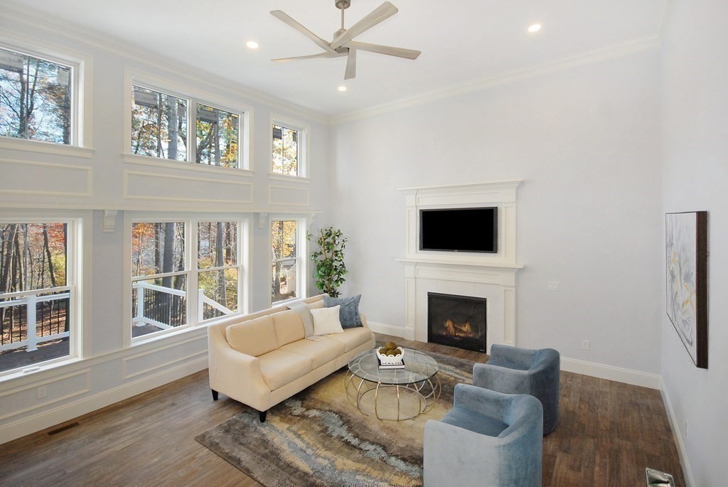 73 Seminole Road Acton, MA 01720 - Photo 8 of 33 a living room with furniture a fireplace and a flat screen tv