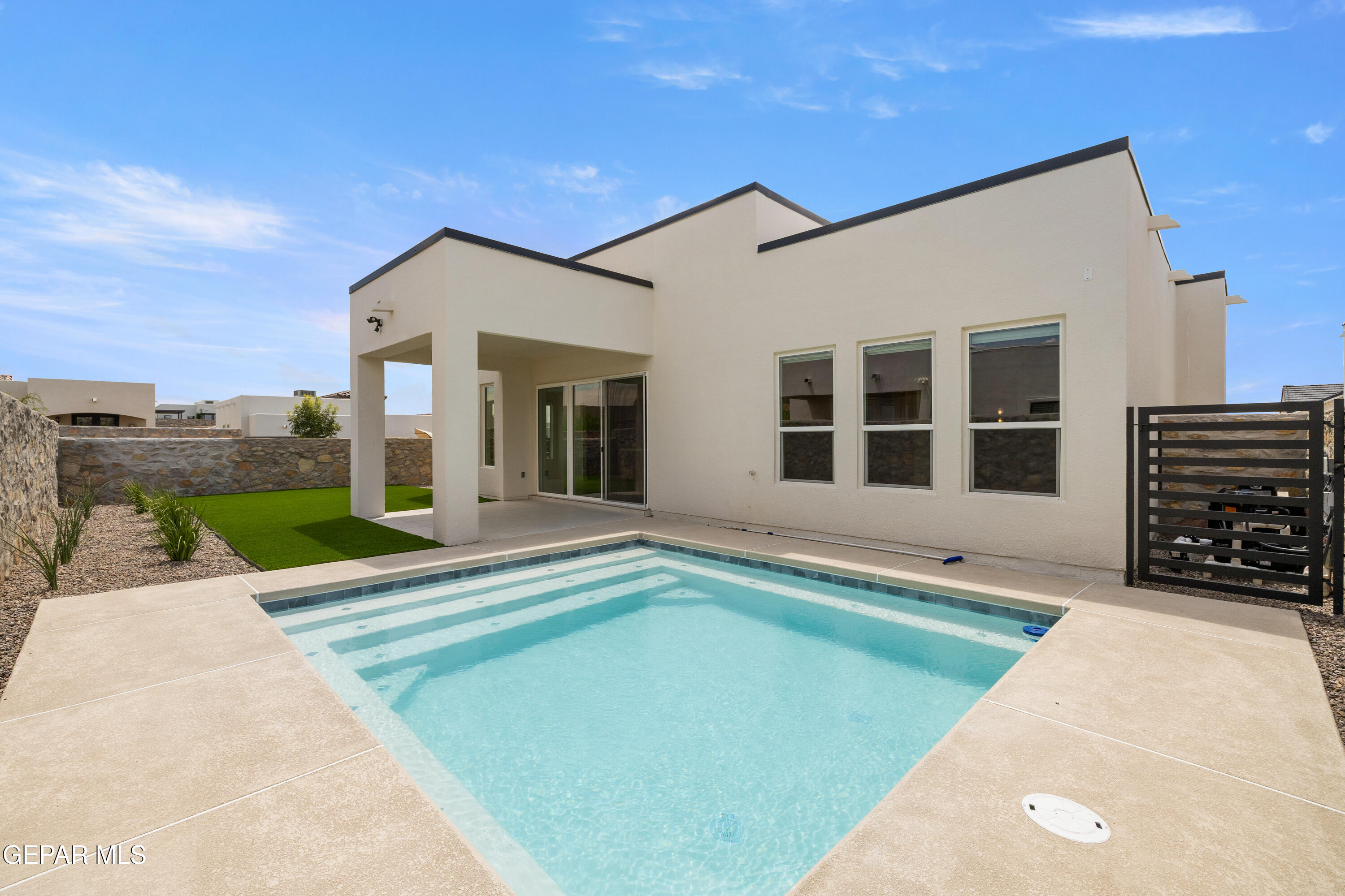 7436 Cimarron Rim Drive El Paso, TX 79911 - Photo 18 of 18 a view of a house with a swimming pool