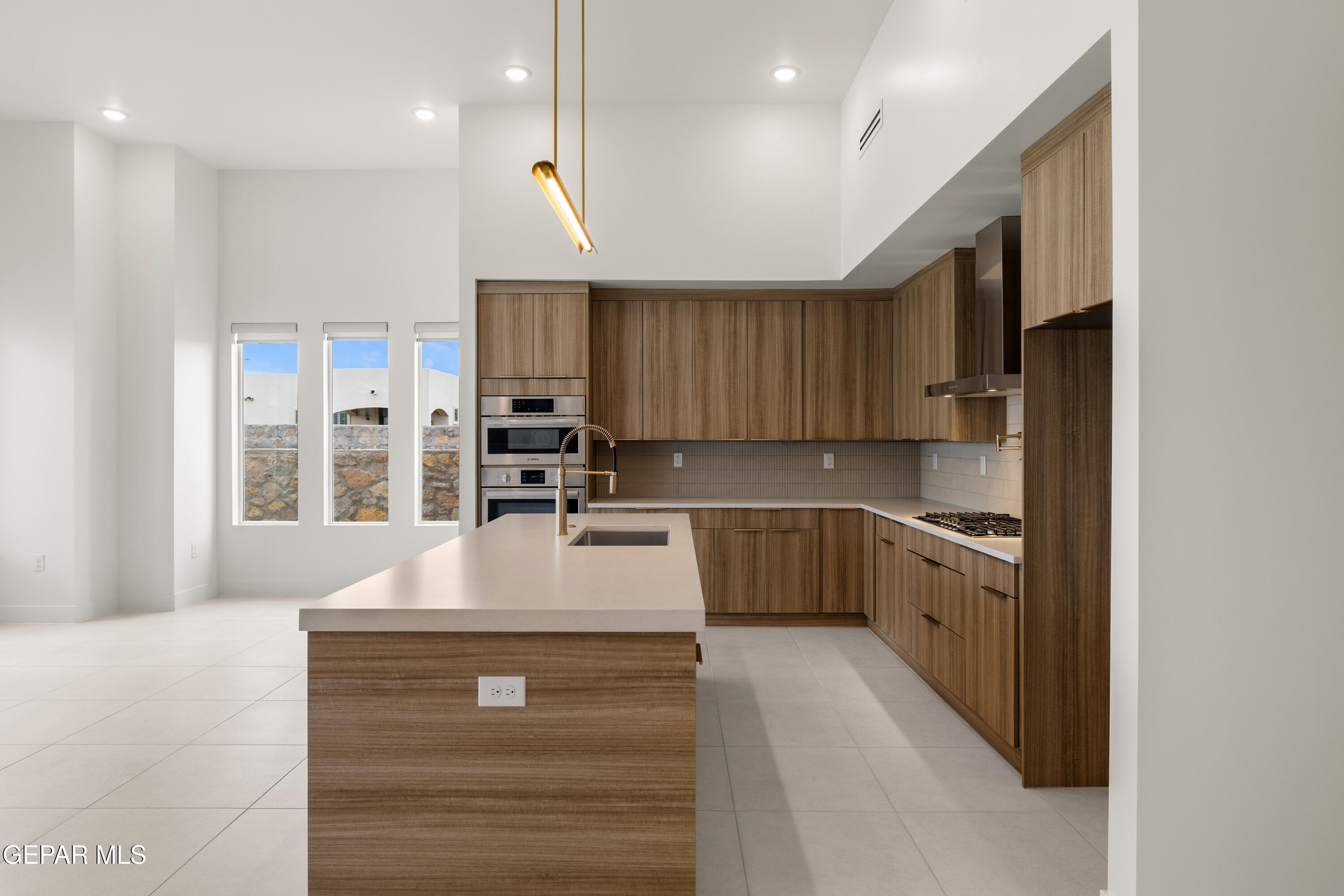7436 Cimarron Rim Drive El Paso, TX 79911 - Photo 3 of 18 a kitchen with kitchen island granite countertop a stove refrigerator and cabinets