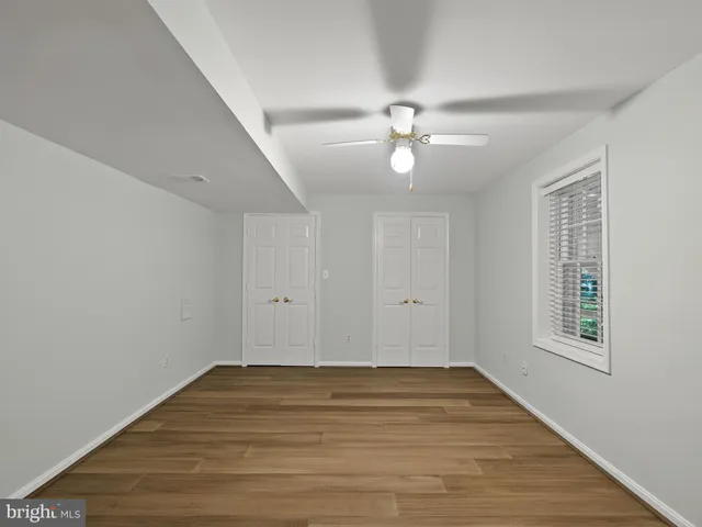 a balcony with wooden floor and trees