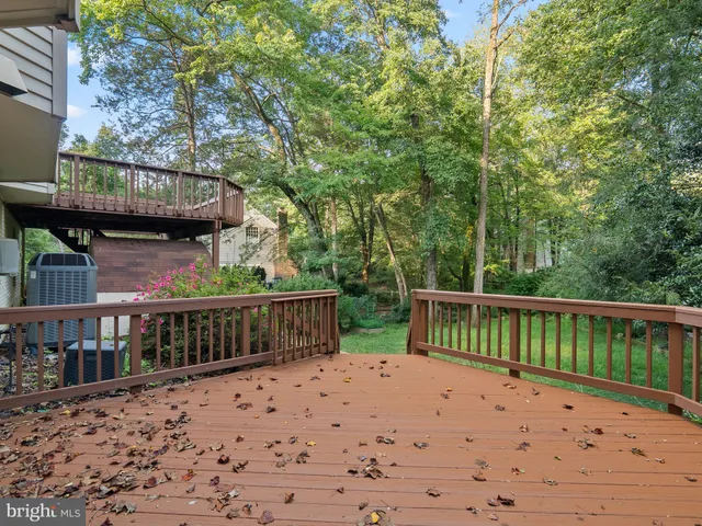 a balcony with wooden floor and outdoor seating