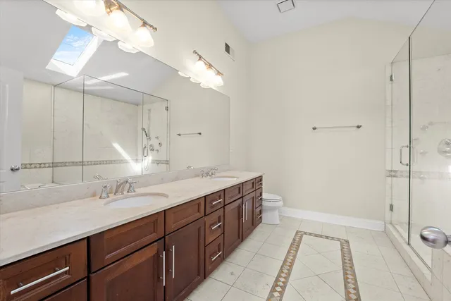 a spacious bathroom with a sink a mirror and a shower