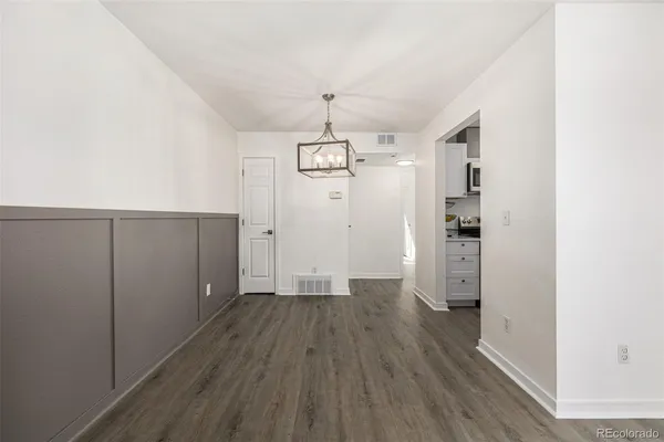 a view of a room with wooden floor closet and windows