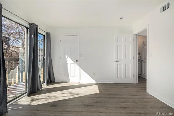 a view of a livingroom with wooden floor and stairs