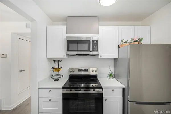 a kitchen with stainless steel appliances white cabinets and a stove