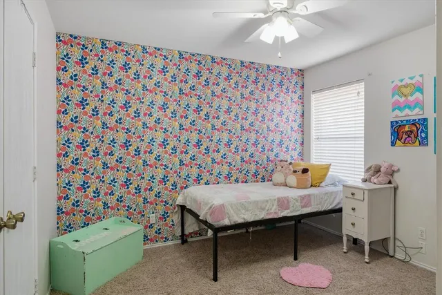 a bedroom with a table and a chandelier