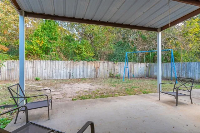 a view of a backyard with a swing