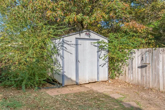 a view of a patio with a table and chairs under an umbrella