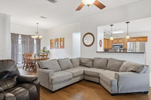 a living room with furniture and kitchen view