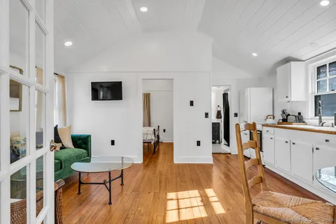 a view of kitchen with furniture and a wooden floor
