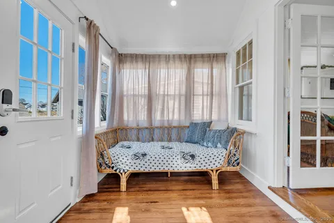 a view of a bedroom with furniture and window