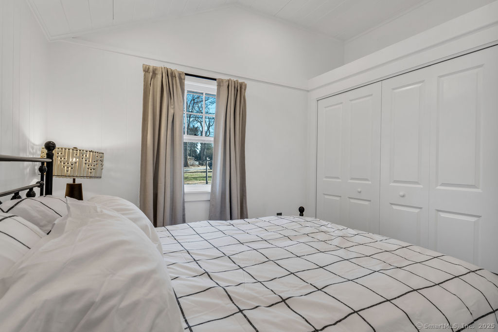 69 Waterside Lane, Unit 2 Clinton, CT 06413 - Photo 5 of 14 a bedroom with a bed and a window