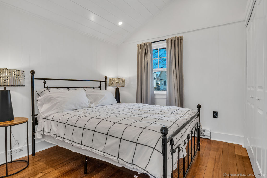 69 Waterside Lane, Unit 2 Clinton, CT 06413 - Photo 6 of 14 a bedroom with a bed and wooden floor