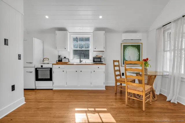 a kitchen with a sink cabinets and wooden floor