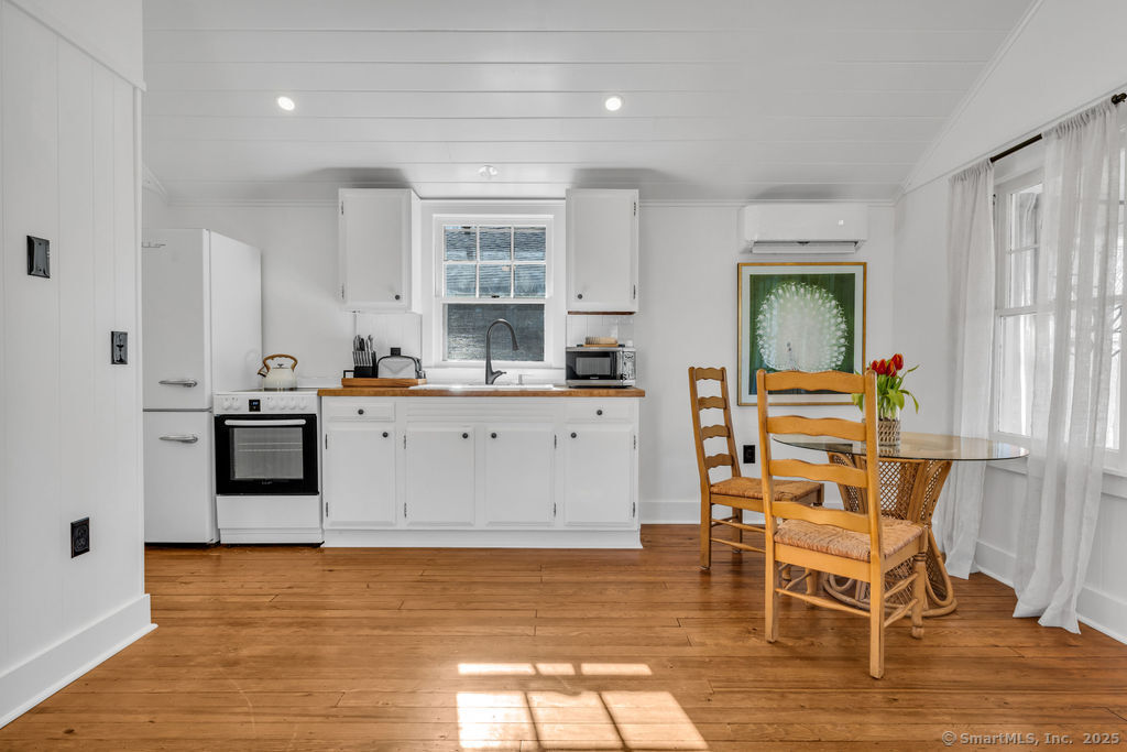 69 Waterside Lane, Unit 2 Clinton, CT 06413 - Photo 7 of 14 a kitchen with a sink cabinets and wooden floor