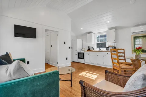 a living room with furniture and flat screen tv