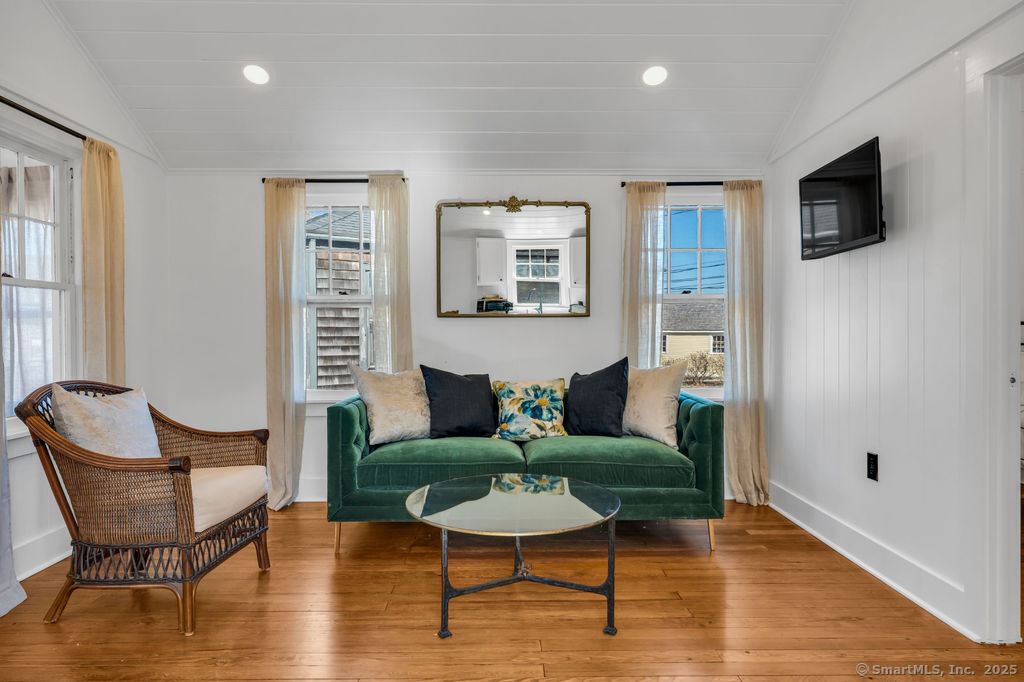 69 Waterside Lane, Unit 2 Clinton, CT 06413 - Photo 9 of 14 a living room with furniture and a wooden floor
