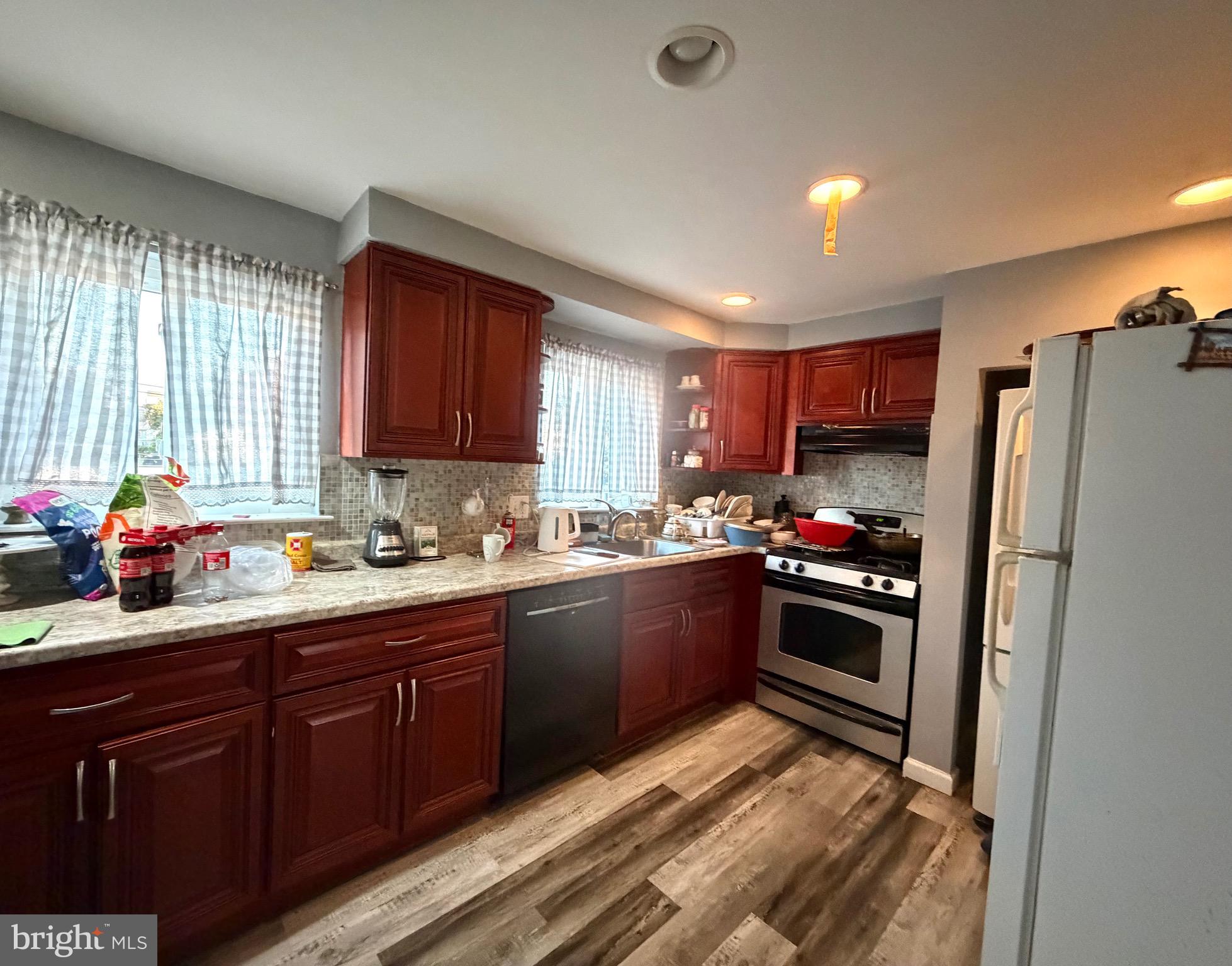 708 Selmer Road Philadelphia, PA 19116 - Photo 3 of 5 a kitchen with kitchen island granite countertop a sink cabinets and stainless steel appliances