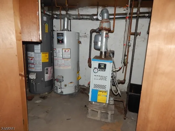 a view of storage and utility room with refrigerator and washer